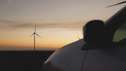 Wind power plants on the background of the car at sunset Stock Footage 103218205