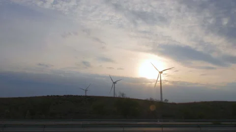 Wind power plants on the highway with passing cars Stock-Footage 58630840