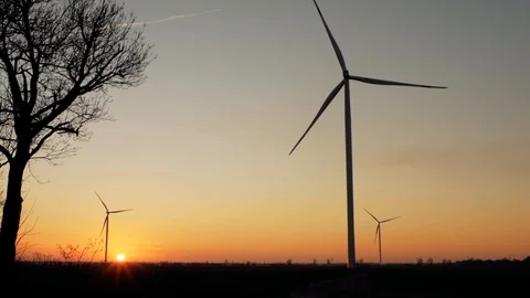 Wind power plants at sunset. wind generators at work Stock Footage 104044185