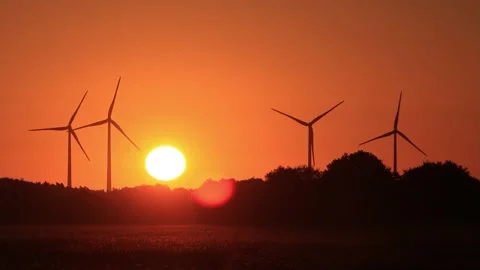 Wind power at sunrise red sky, clean and renewable energy  Stock Footage 218779520