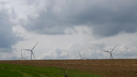 Wind power turbines with a cloudy sky in background Stock Footage 98010662