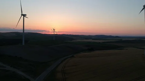 Wind power turbines generating renewable clean energy at sunset Stock Footage 129964341