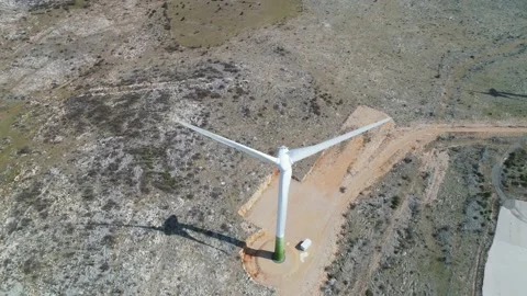 Wind power turbines under Velebit mountain view, Alkaline pool from abandoned Stock Footage 157055978