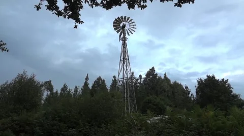 Wind propeller mounted on a tall pole that draws water from deep Stock Footage 62692031