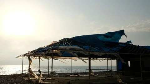 The wind ruffles a torn canvas of blue color Stock Footage 132665938