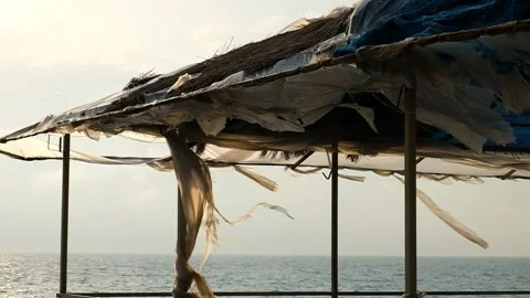 The wind ruffles a torn canvas of blue color Video stock 132667148