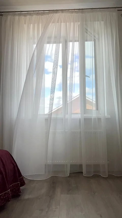 Wind ruffles tulle on open window. Stock Footage 260324530