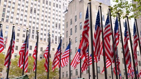 Wind slowly flaps multiple American flags on the flagstaffs outdoors. Stock Footage 321183311