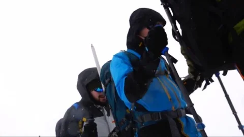 Wind, snow, climbers ascend the mountain. Motivation. Success Stock Footage