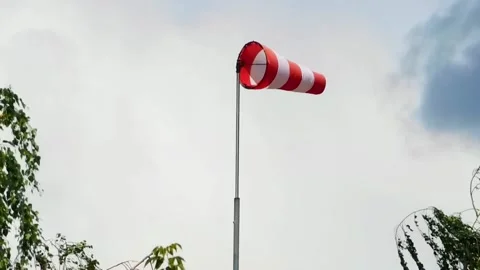 Wind sock, red and white pointer indicating strength and direction of the wind Stock Footage 162363850