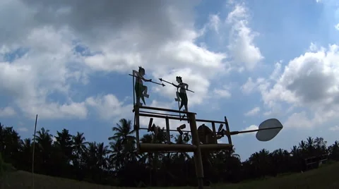 Wind spinner over-looking a quiet rice paddy Stock Footage 61043574