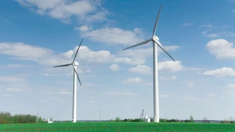 Wind stations are spinning against the beautiful blue sky. Stock Footage 75619261