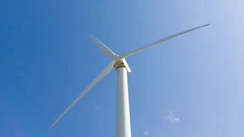 Wind stations are spinning against the beautiful blue sky. Stock Footage 75619543
