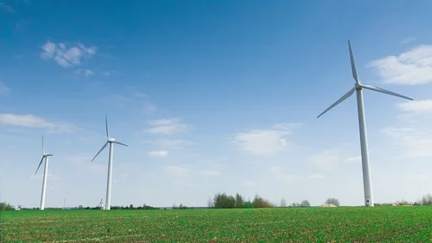 Wind stations are spinning against the beautiful blue sky. Stock Footage 75627916