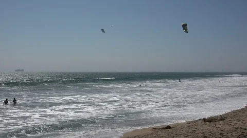 Wind surfing off the coast of Sunset Beach in southern California Stock Footage 113963378