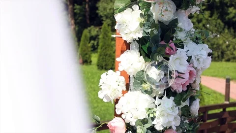 The wind sways canvas, flowers and hanging candles on the wedding arch Stock Footage 101254634