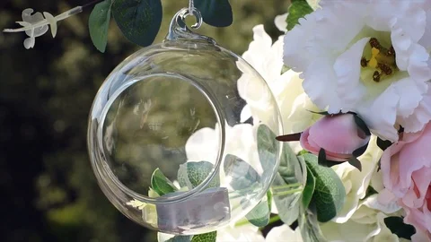 The wind sways flowers and hanging candles on the wedding arch Stock Footage 101254618