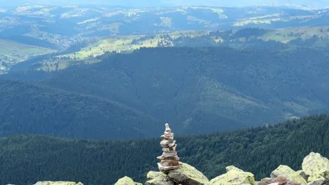 Wind sweeping across a mountain top cairn amidst breathtaking scenery Stock Footage 282129536