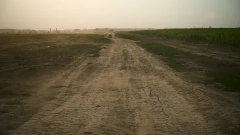 Wind sweeping dust across an arid rural dirt track. Concept of severe droug.. Stock Footage 342342329