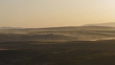 Wind sweeps sand from dunes and hills at sunset, Hurricane, US Stock Footage 287732803