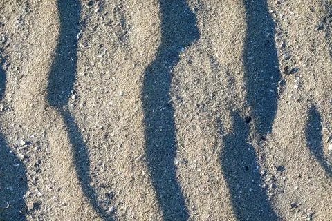 Wind swept ridges in granular beach sand Stock Photos