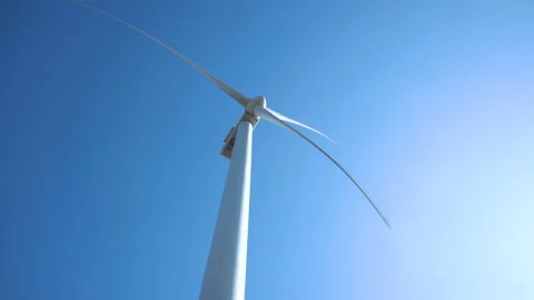 Wind turbine against clear sky on sunny day Stock Footage 100550554
