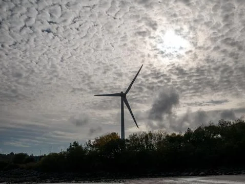 Wind turbine against dramatic cloudy sky 库存照片
