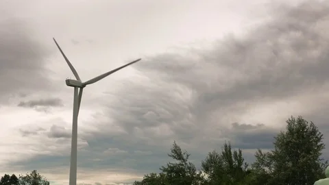 Wind turbine and tree dramatic cloudy sky England August 2017 Stock Footage 83727963