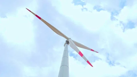 Wind turbine on the background of blue sky in summer with moving clouds Stock Footage 249925732