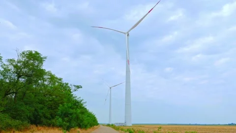 Wind turbine on the background of blue sky in summer with moving clouds Stock Footage 249925925