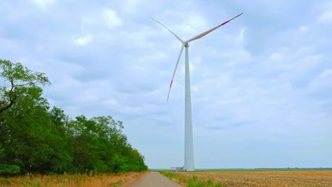 Wind turbine on the background of blue sky in summer with moving clouds Stock Footage 249925930