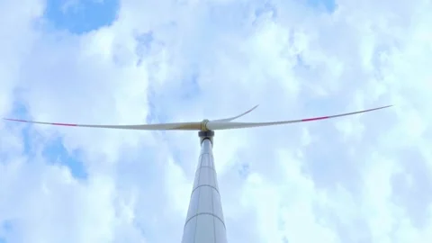 Wind turbine on the background of blue sky in summer with moving clouds Stock Footage 249939340
