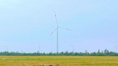 Wind turbine on the background of blue sky in summer with moving clouds Stock Footage 249939484