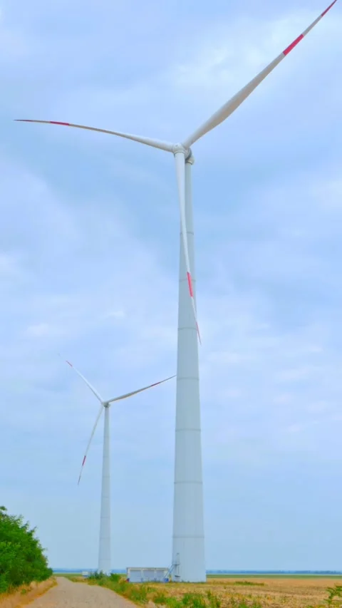 Wind turbine on the background of blue sky in summer with moving clouds Stock Footage 249941449