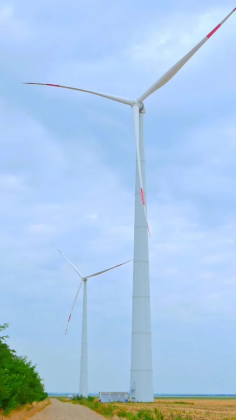 Wind turbine on the background of blue sky in summer with moving clouds Stock Footage 249941450