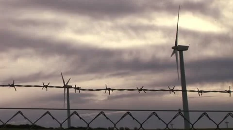 Wind turbine with barbed wire in foreground Video stock 12499698