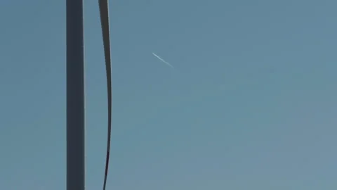 Wind Turbine Blade and Contrail in Blue Sky Stock Footage 282926596