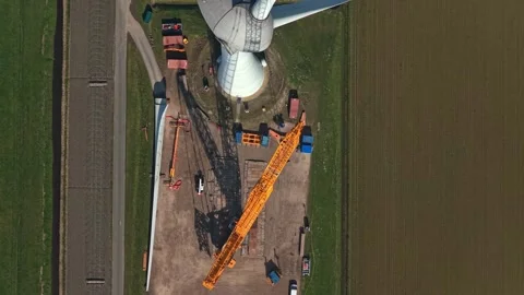 Wind turbine blade assembly crane operation top down aerial view Video stock 332850488