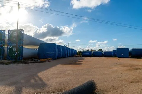Wind turbine blade sections with covers in storage yard Stock Photos