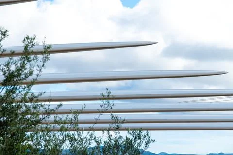 Wind turbine blade tips lined up against cloudy sky Photos