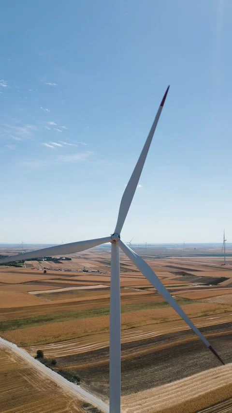 Wind turbine blades rotating over agricultural fields Stock Footage 344601796