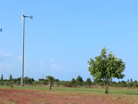 Wind turbine on blue sky background Stock Footage 73720427