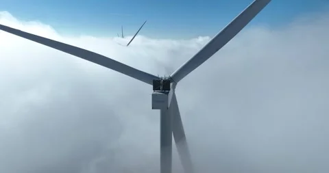 Wind turbine in the clouds, above the clouds, clean energy, aerial video. Stock Footage 311311846
