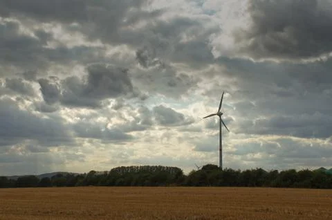 Wind turbine in a cloudy sky Stock Photos