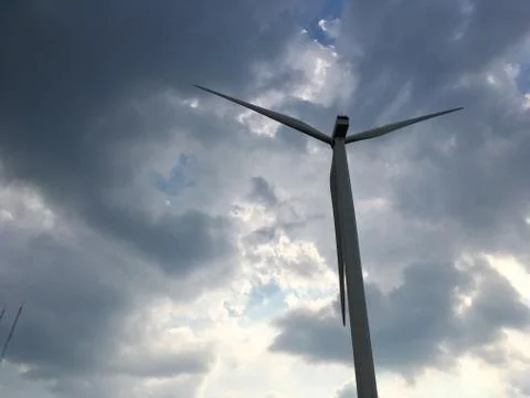 Wind turbine on cloudy sky Fotos Stock