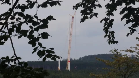 A wind turbine construction site in a forest video Stockbeeldmateriaal 248789019