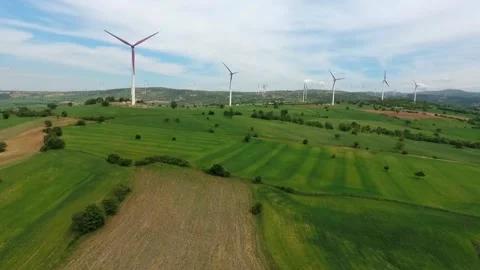 A wind turbine is a device that converts the winds kinetic energy into elec.. Stock Footage 236706790