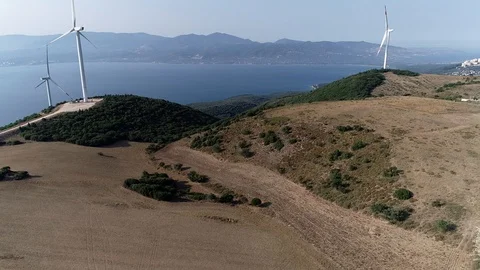 The wind turbine does not work. In the background are also sea and mountains Stock Footage 122156658