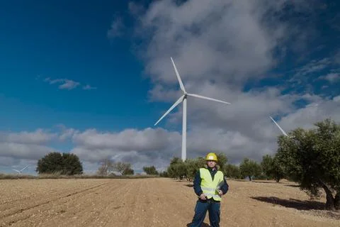 Wind turbine engineer inspecting a wind farm for renewable energy production Stock Photos