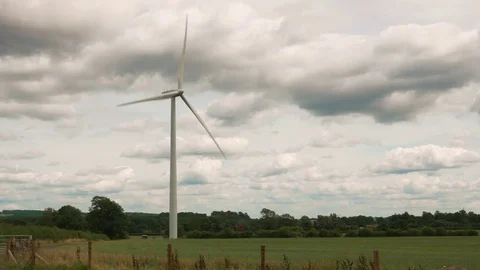 Wind turbine in field against cloudy sky Stock Footage 83729095